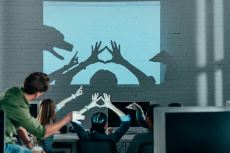 young people playing with shadows after work in modern office