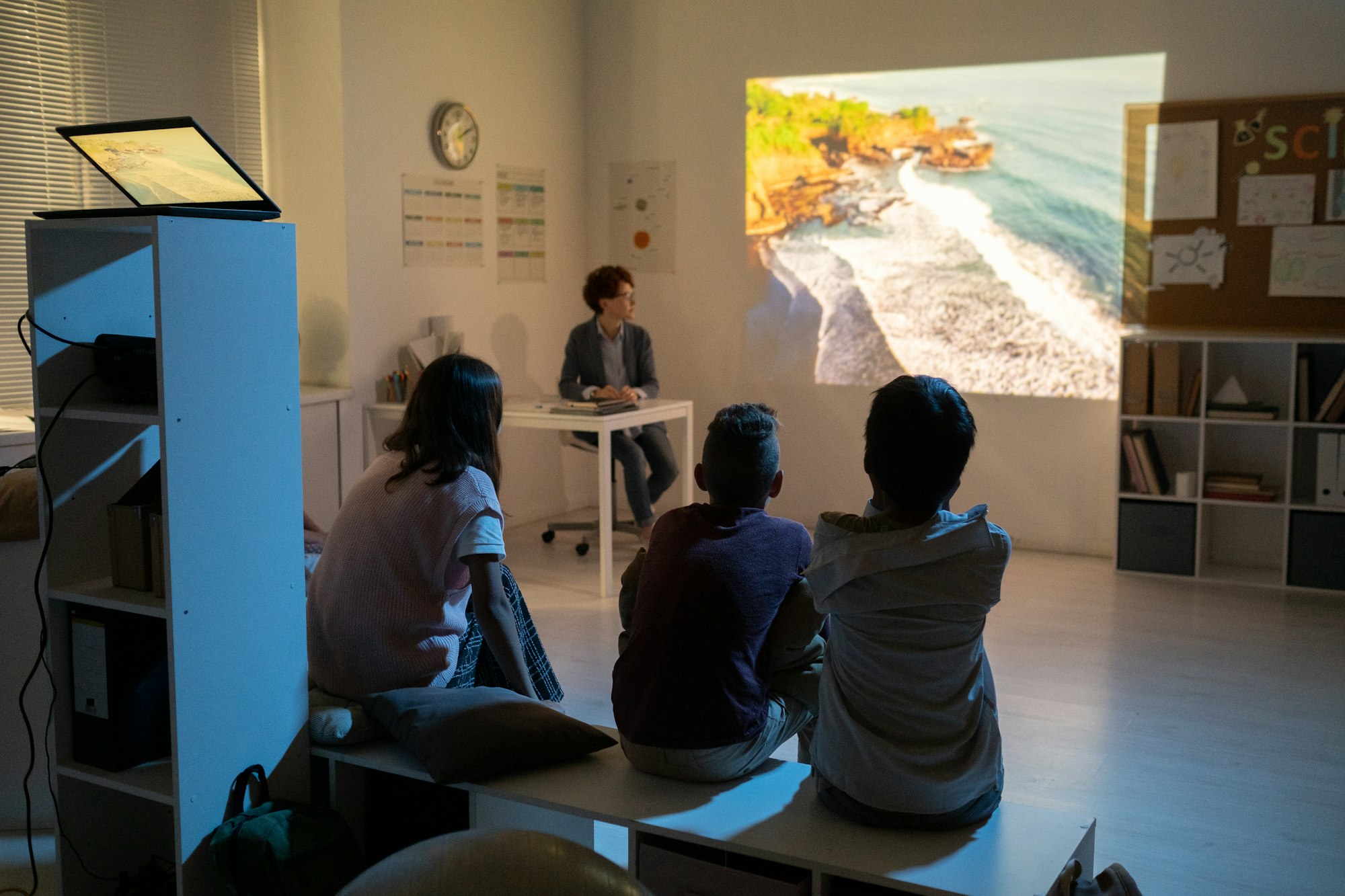 Schoolkids watching movie about natural environment